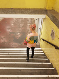 Full length of woman on steps in city