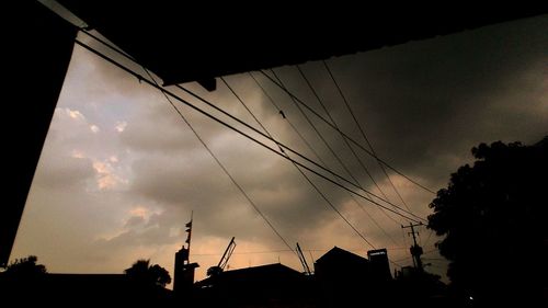 Low angle view of electricity pylon against sky