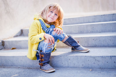 Smiling girl sitting on steps