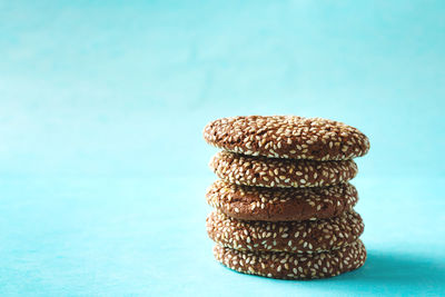 Close-up of stack on table against blue background