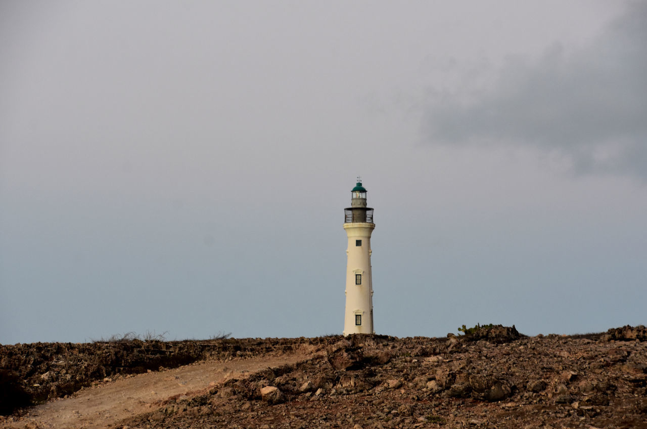 guidance, lighthouse, tower, architecture, built structure, building exterior, security, building, protection, sky, sea, nature, beach, land, no people, travel destinations, water, coast, travel, observation tower, day, cloud, house, coastline, environment, outdoors, landscape, history, copy space, scenics - nature, navigational equipment, sand dune, non-urban scene, the past, assistance, nautical equipment, ocean, water's edge