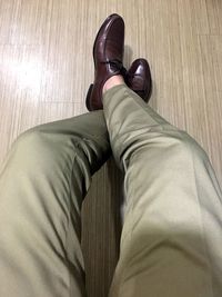 Low section of man wearing shoes