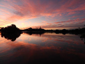 Scenic view of lake against orange sky