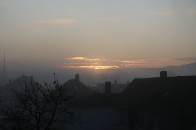 Silhouette buildings against sky during sunset