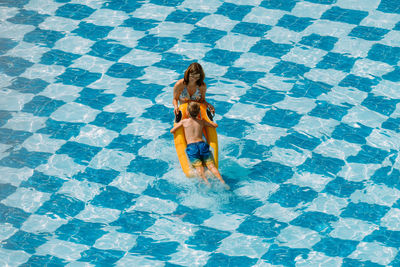 High angle view of woman swimming in pool