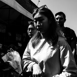 Low angle view of young woman looking away