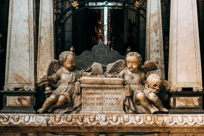 Statue against historic building