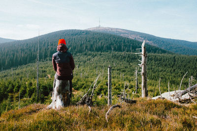 Man standing on field against sky