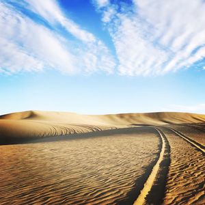 Scenic view of desert against blue sky