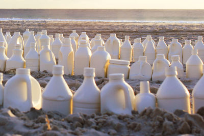 Close-up of bottles on beach