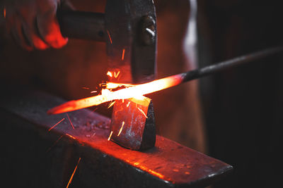 Close-up of hand holding burning fire