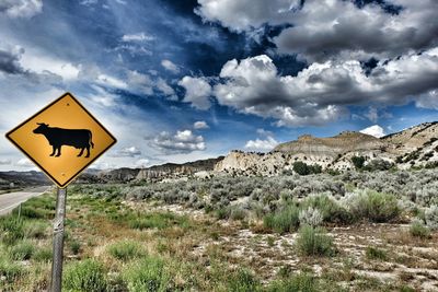 Scenic view of landscape against cloudy sky