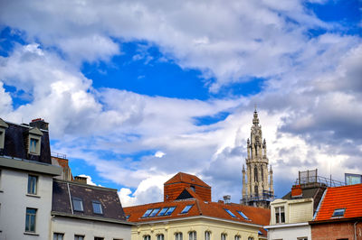 Low angle view of buildings against cloudy sky