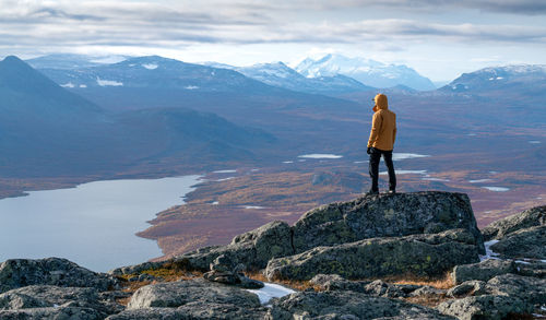 Rear view of woman walking on mountain