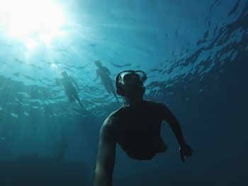 Low angle view of man swimming in sea