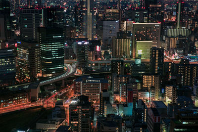 High angle view of city lit up at night