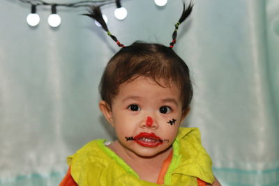 Asian girls make ghosts of red lipstick for halloween