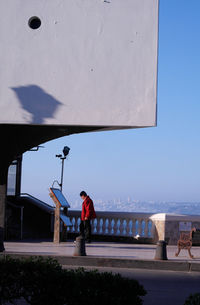 Man standing by sea against clear sky