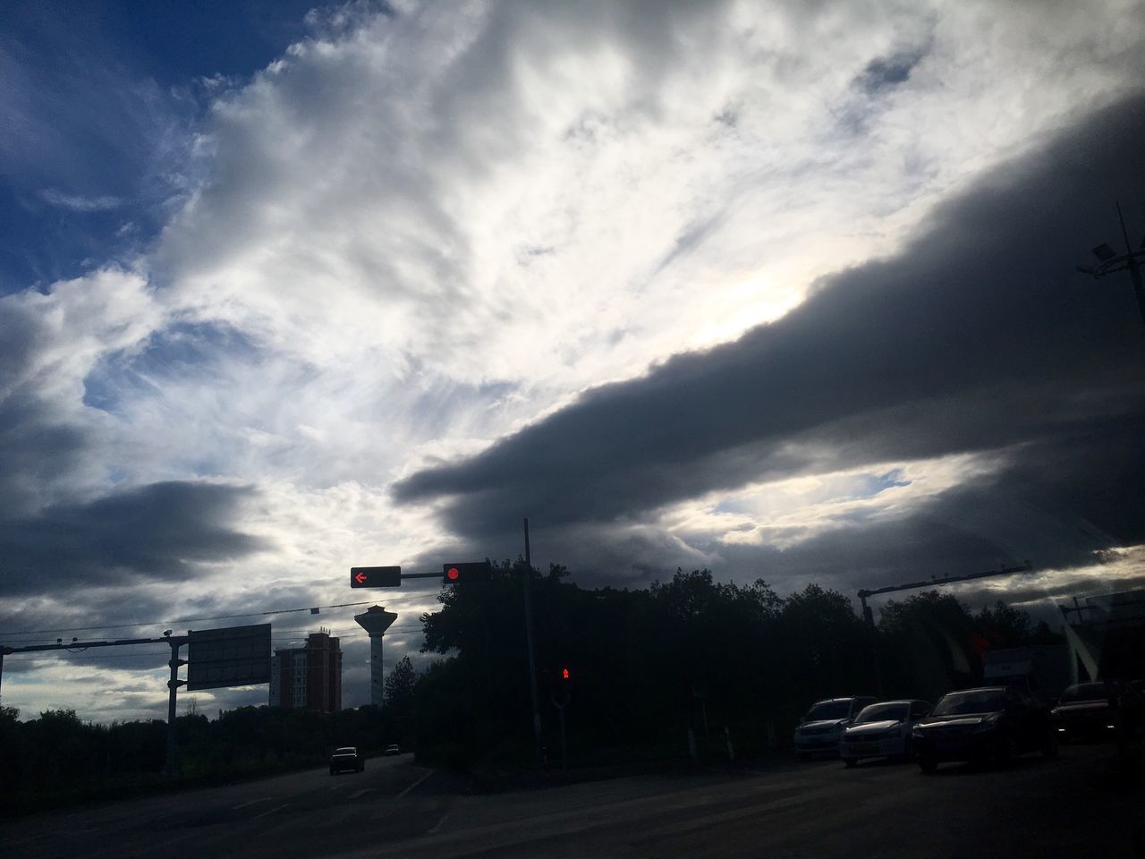 cloud - sky, transportation, sky, car, road, street, outdoors, land vehicle, no people, mode of transport, built structure, architecture, building exterior, road sign, tree, city, day, nature