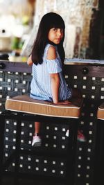 Full length of woman sitting on chair at table