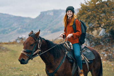 Young woman riding horse