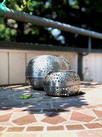 Close-up of metallic container on tiled floor