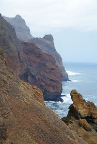 Scenic view of sea and mountains against sky