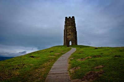 Ancient historical building against cloudy sky