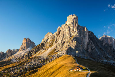 Scenic view of mountains against clear blue sky