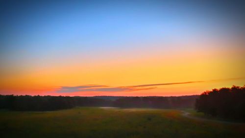 Scenic view of landscape against sky at sunset