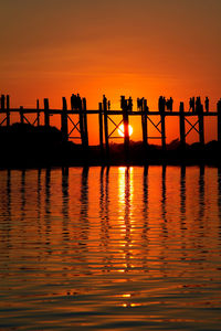 Silhouette bridge against sky during sunset