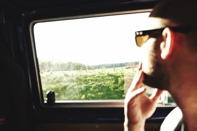 Cropped image of woman looking through airplane window