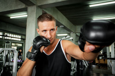 Man practicing boxing in gym