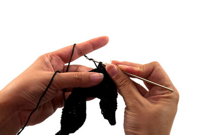 Cropped hands of woman knitting