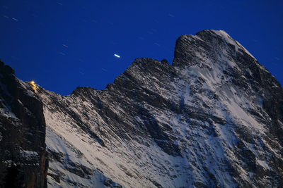 Low angle view of snowcapped eiger against clear sky at dusk