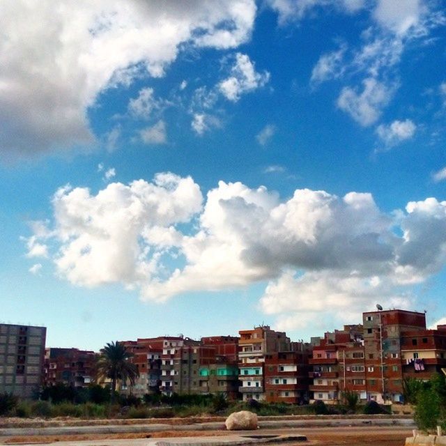 building exterior, architecture, built structure, sky, house, cloud, cloud - sky, city, residential structure, residential building, blue, road, street, day, outdoors, residential district, building, cloudy, tree, town