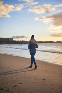 Full length rear view of man standing on beach