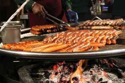 Close-up of people on barbecue grill