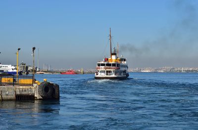 Boats in sea against clear sky