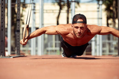 Portrait of young man exercising in gym