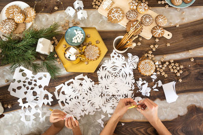 Directly above shot of woman making christmas decoration