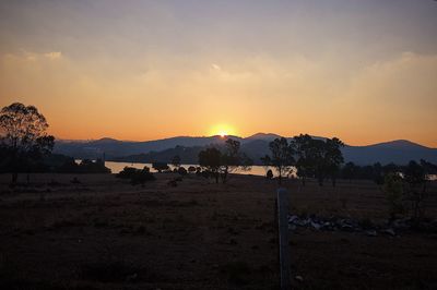 Scenic view of field against sky during sunset