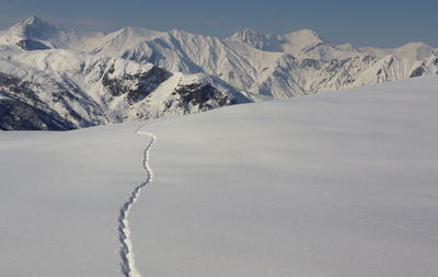 Scenic view of snow mountains against sky