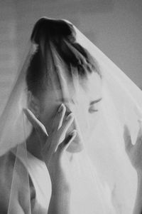 Rear view of woman looking through window