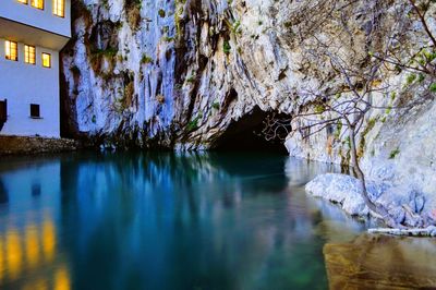Scenic view of cave by water