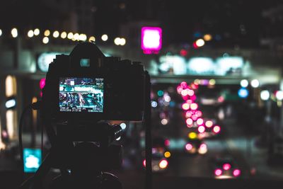 Close-up of illuminated camera at night