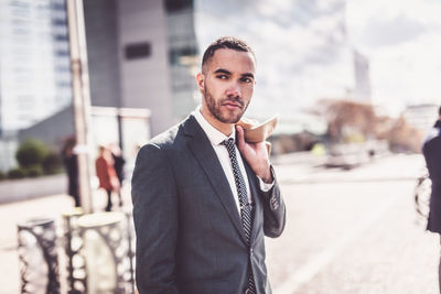 Portrait of man standing in front of office building