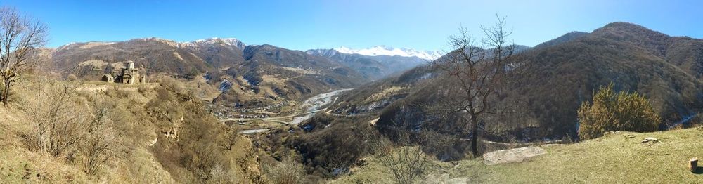 Panoramic view of mountains against clear sky