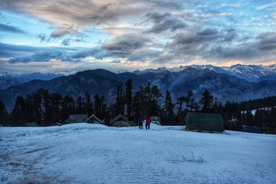 Scenic view of snow covered field against sky