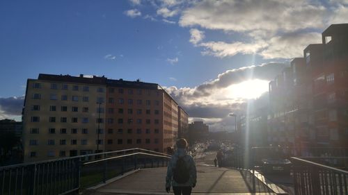 Rear view of man walking on street in city